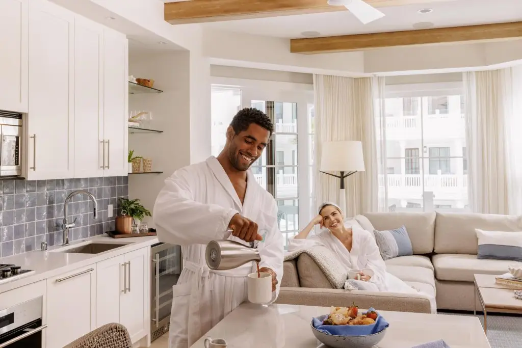 A young couple in bathrobes enjoying a cup of coffee in their hotel room - Hotel Photography - Shore House at the Del