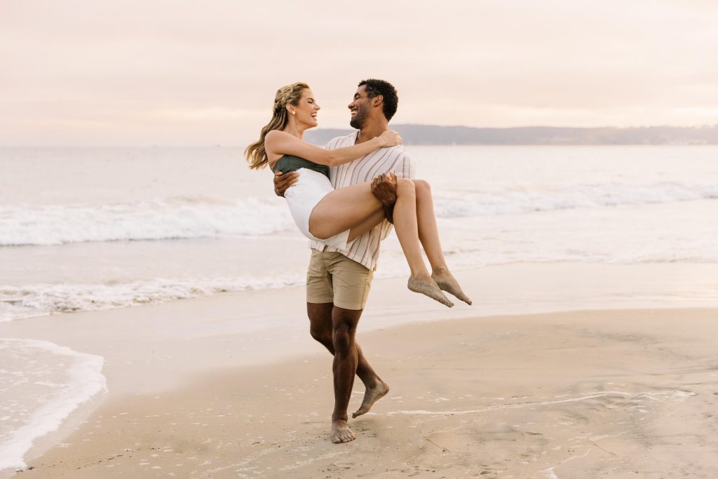 A young couple in romance on a beach at dusk - Hotel Photography - Shore House at the Del