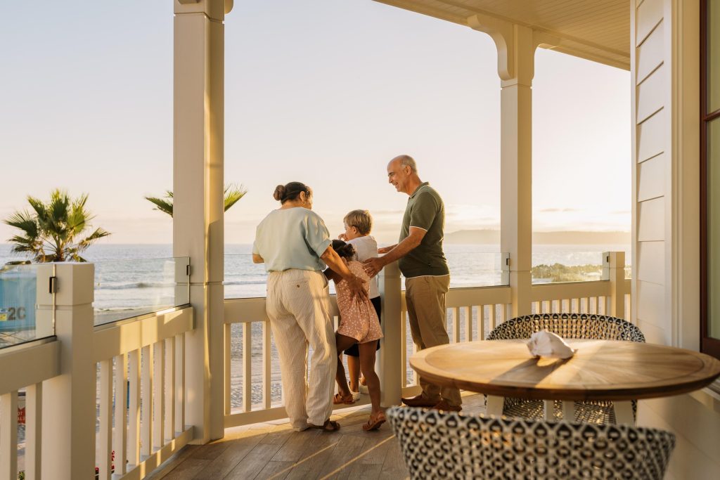 Older couple and grand children by a beach side balcony Hotel Photography - Shore