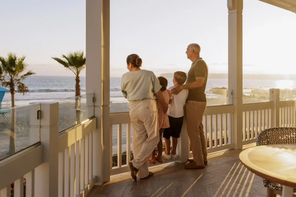 Older couple and grand children by a beach side balcony Hotel Photography - Shore House at the Del