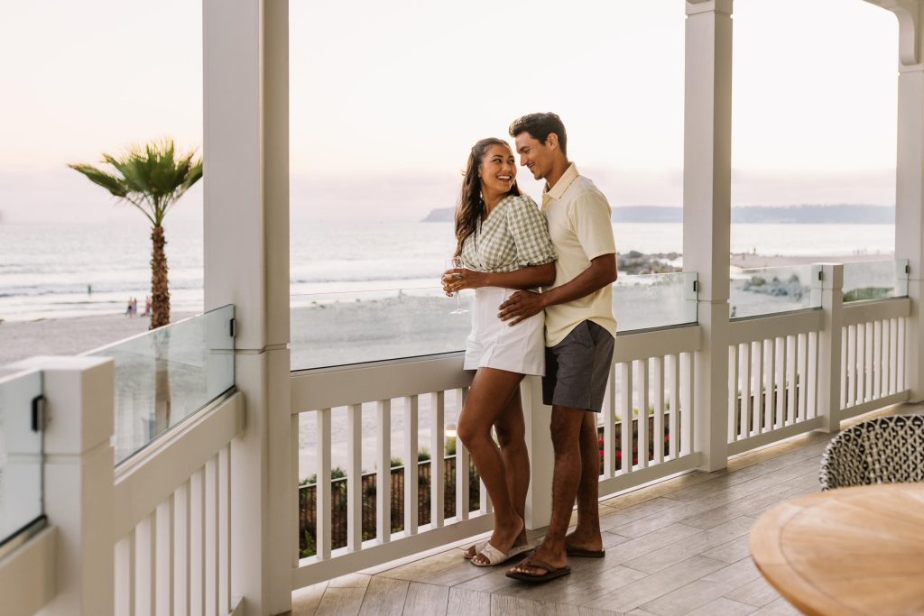 a young couple by a beach side balcony Hotel Photography - Shore House at the Del